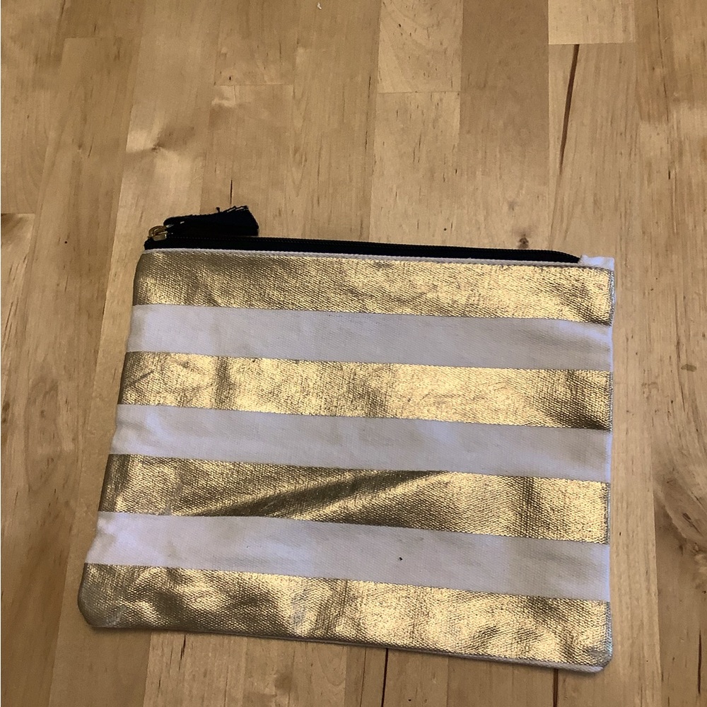 GUC Gold and white cosmetic bag.